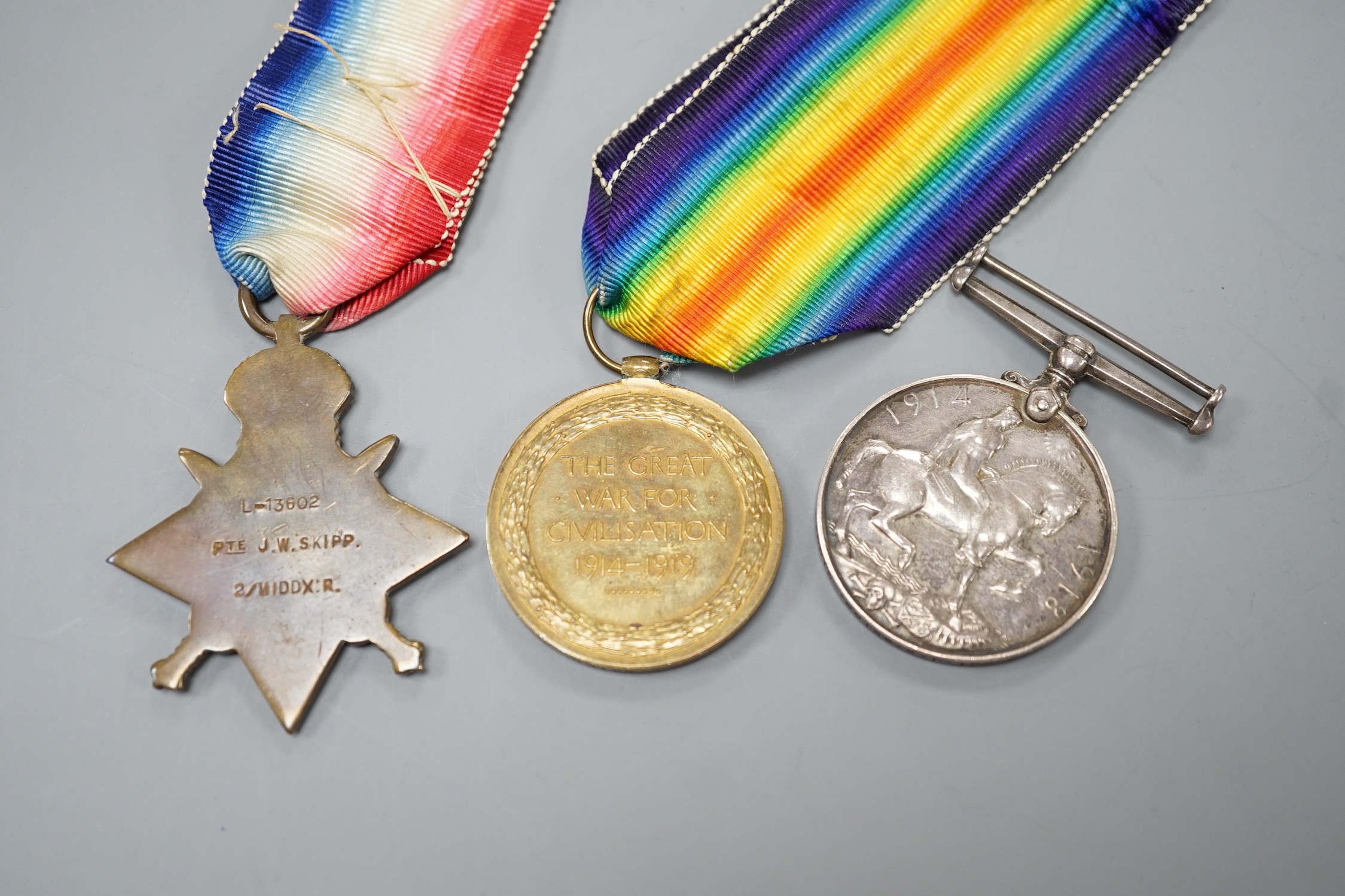 A WWI Mons star (with clasp and rosette) trio to L-13603 PTE. J.W. SKIPP. 2/MIDDX: R.